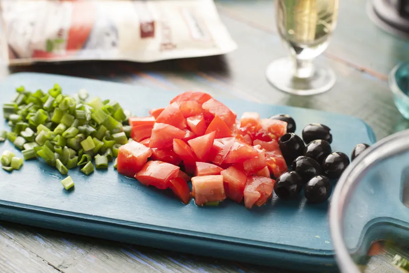 Овочі і сир фета нарізати середнім кубиком, зелена цибуля - пір'ям, базилік - порвати, маслини - розрізати на половинки.